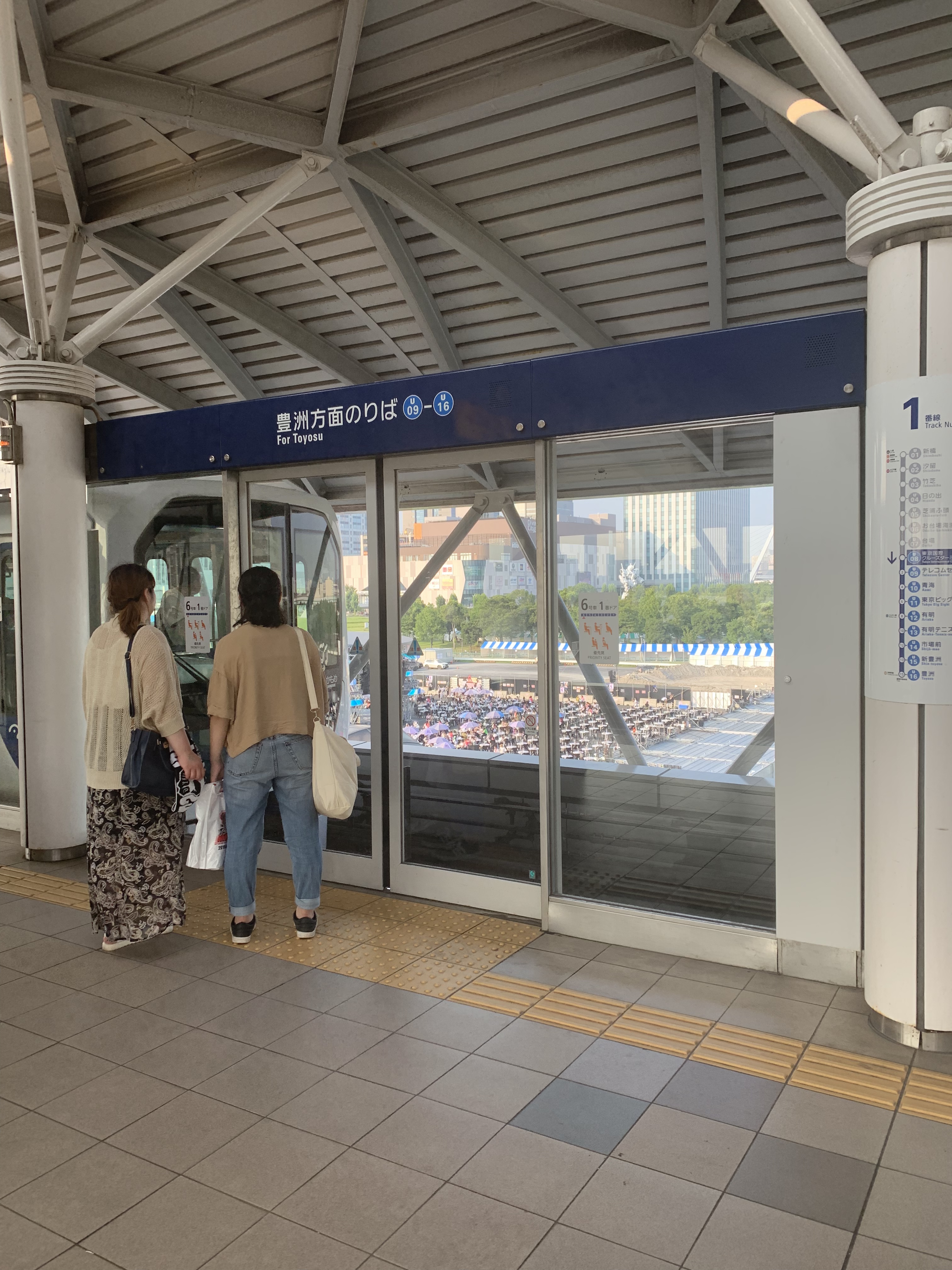 Two women waiting for subway: Customers line up at automated doors in a subway system in Tokyo.